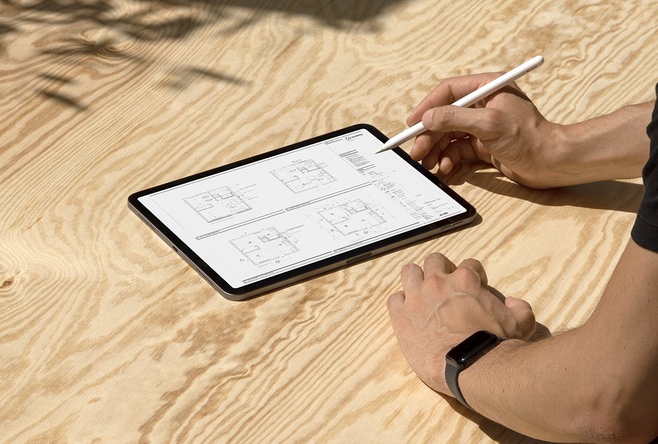 Hands reviewing Buildoly site plans on a tablet with an Apple Pencil
