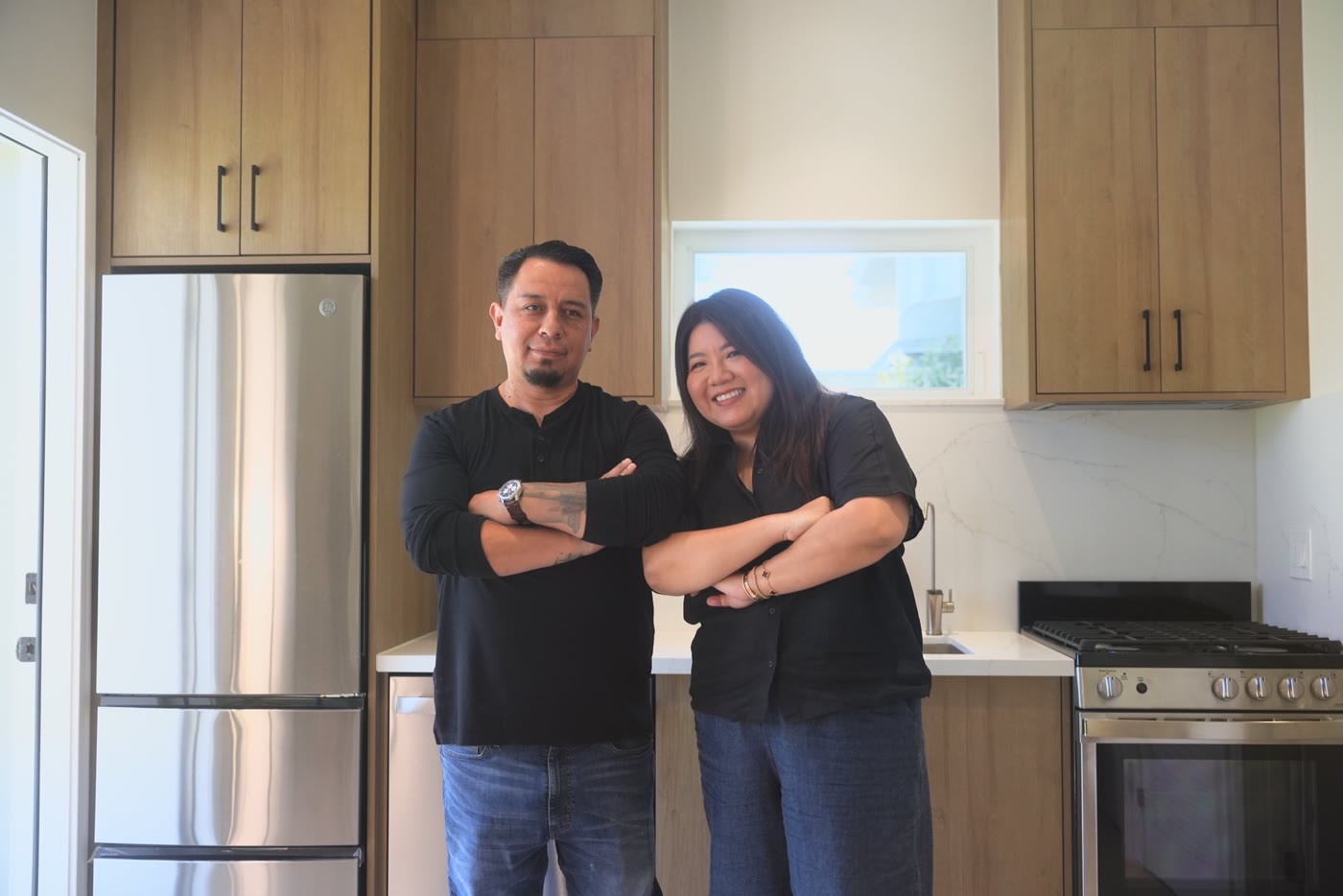 Jamie and her partner in the kitchen of her finished ADU
