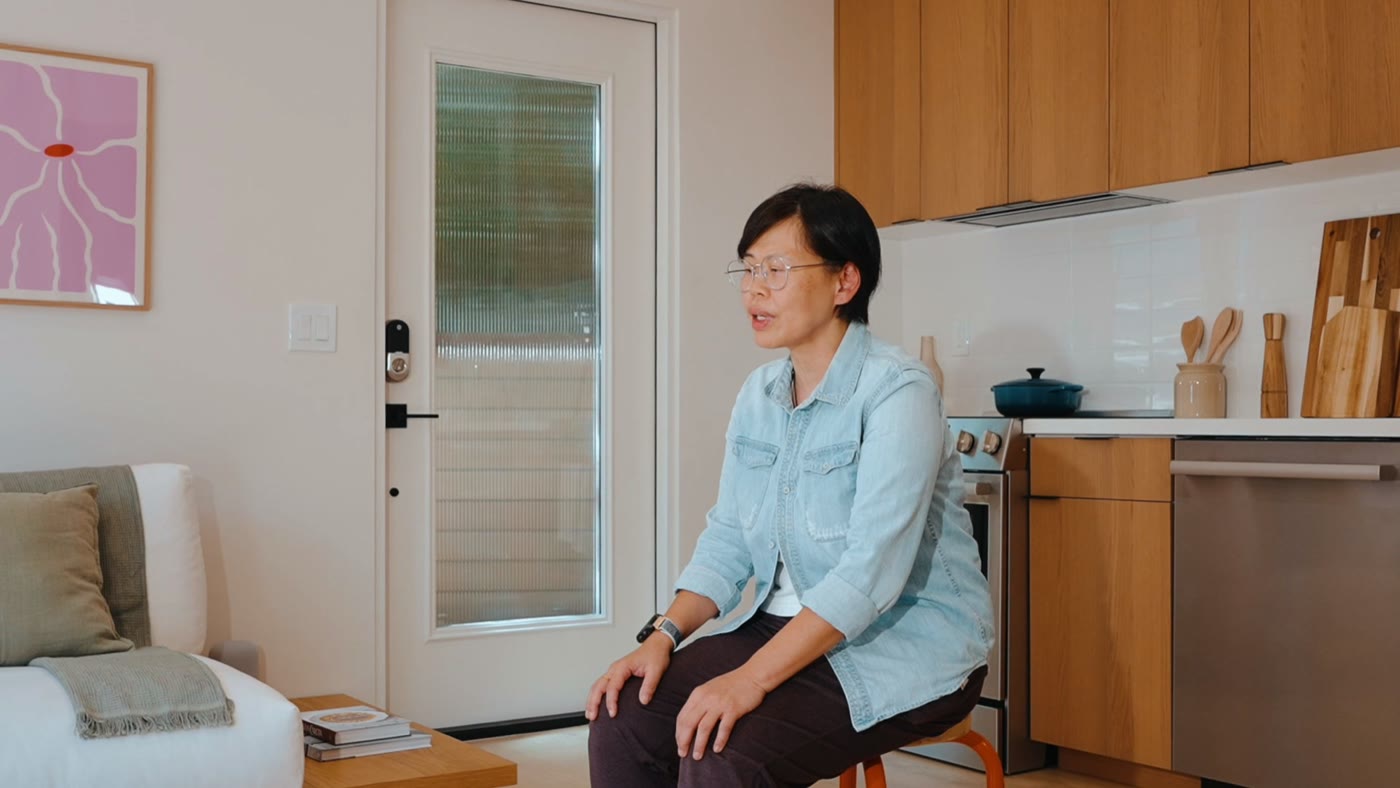 Pam seated by the front door of her ADU in Diamond Bar