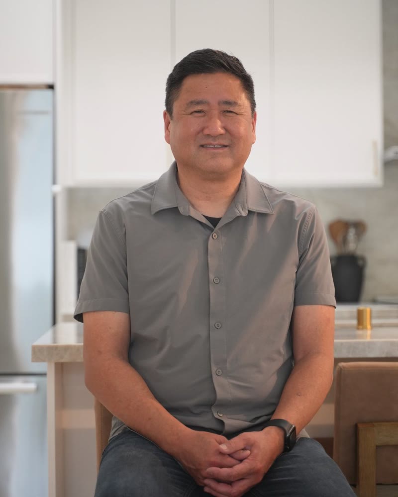 John seated at the kitchen island of his ADU in Yorba Linda